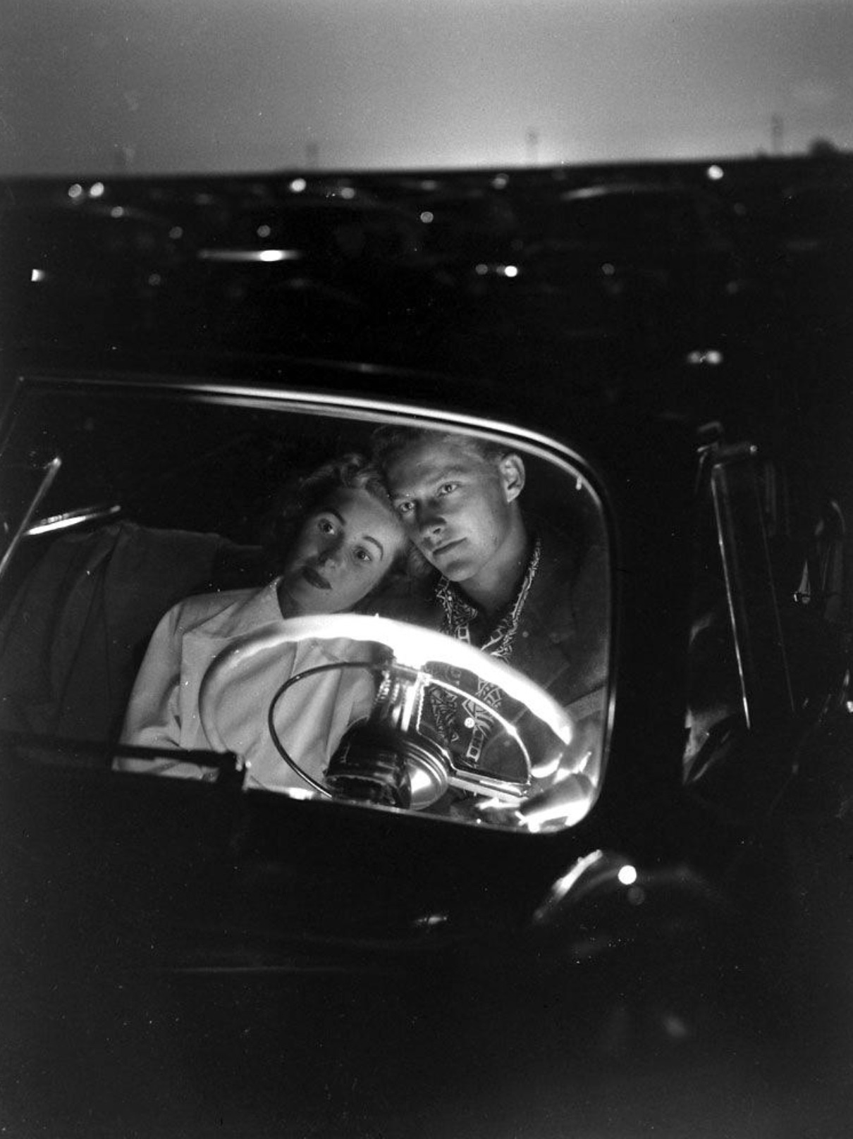 A couple at a drive-in movie theater, photographed by J. R. Eyerman, 1949 